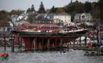 Bluenose II is winched into the water during the relaunch Saturday in Lunenburg