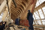 Shipbuilders replace the wood on BluenoseII's hull.