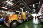 Truck and ferry are parked on the ferry heading to New Brunswick.