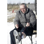 Premier Darrell Dexter skates with some kids on a homemade outdoor rink in Membertou.