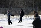 Premier Darrell Dexter laces up a pair of skates to try out a homemade outdoor rink in Membertou.