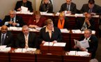 Premier Darrell Dexter reads his copy of the budget address as Finance Minister Maureen MacDonald delivers her speech.