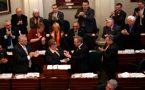 Premier Darrell Dexter presents Finance Minister Maureen MacDonald with a small bottle of black ink after her budget address, signifying the province's return to the black.