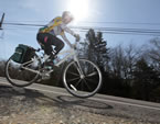 A cyclist on the shoulder of the road.