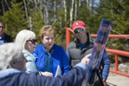 Community Services Minister Denise Peterson Rafuse, on behalf of Natural Resources Minister Charlie Parker, watches as residents look at map of the opened roads.