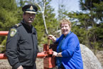 Community Services Minister Denise Peterson Rafuse, on behalf of Natural Resources Minister Charlie Parker, opens the gate.