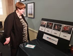 Status of Women Minister Marilyn More looking at the Don't Be That Guy campaign posters