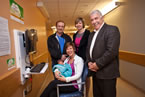 From left: New father Chris Richard, Michelle LeDrew, director, Women's and Newborn Health Program, IWK, and Service Nova Scotia and Municipal Relations Minister John MacDonell, stand behind Heather Richard with daughter Neaven.