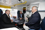 FROM LEFT: Keith Condon, president of Tri-Star Industries, Premier Darrell Dexter and Health and Wellness Minister David Wilson chat inside an ambulance.