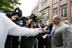 Premier Darrell Dexter answers question during a media scrum.