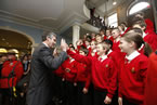 Premier Stephen McNeil high fives a member of the Halifax Boys Honour Choir after they performed at a repletion for the Executive Council at Province House.