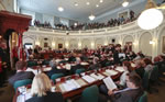 Members and guests of the House of Assembly listen to the throne speech.