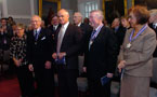 Order of Nova Scotia recepients stand in the front row of the audience during the ceremony.