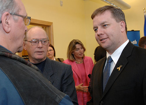 Premier Rodney MacDonald and Education Minister Judy Streatch talk to audience members after the announcement.