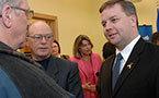 Premier Rodney MacDonald and Education Minister Judy Streatch talk to audience members after the announcement.