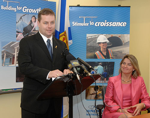 Education Minister Judy Streatch listens as Premier Rodney MacDonald announces investments in school construction.
