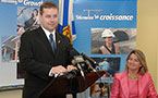 Education Minister Judy Streatch listens as Premier Rodney MacDonald announces investments in school construction.