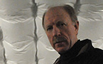 Jeremy Lee, co-owner of of Sustainable Fish Farming Canada Ltd., stands beside one of the sea bass tanks.