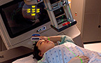 A linear accelerator moves around a patient during radiation therapy.