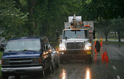 Power crews inspect a downed powerline in central Halifax during Hurricane Bill on Sunday afternoon.